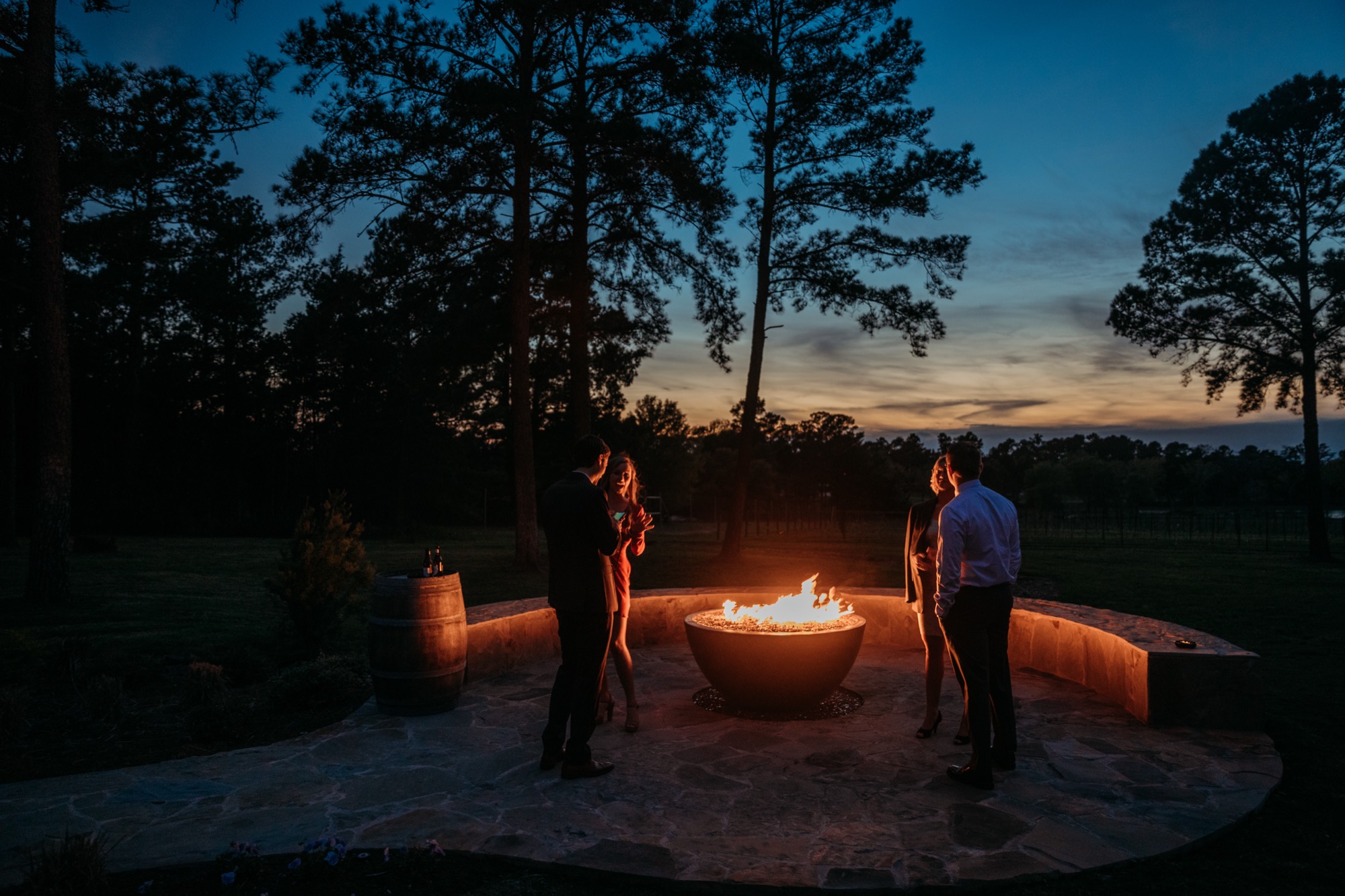 Guests around the fire pit at dusk